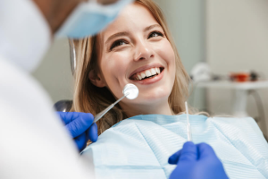 Woman Smiling during a dental checkup.