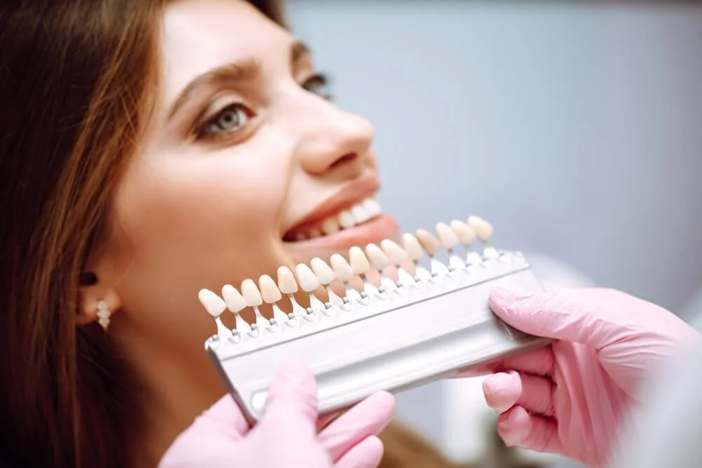 Woman smiling while matching tooth color