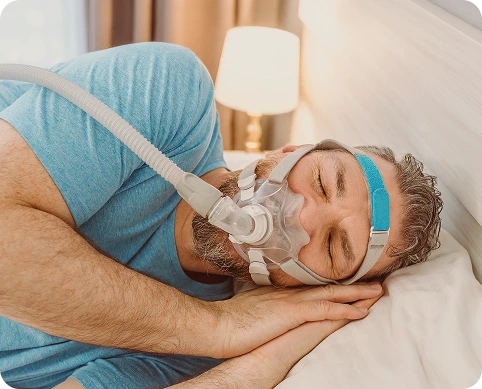 Man sleeping with a CPAP mask.